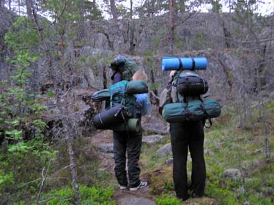 Hikers standing in front of a cliff